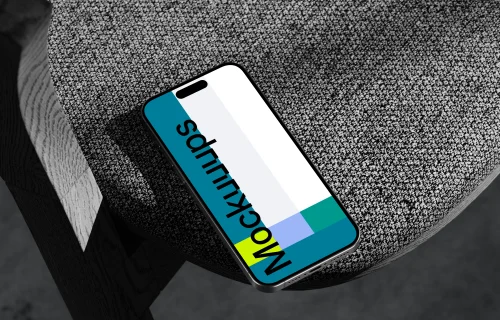 iPhone 15 Pro mockup on textured rock surface with dramatic lighting