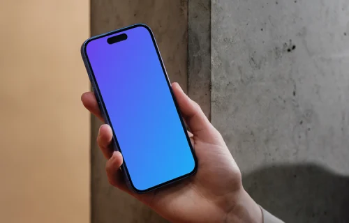 iPhone 16 mockup held against a concrete wall