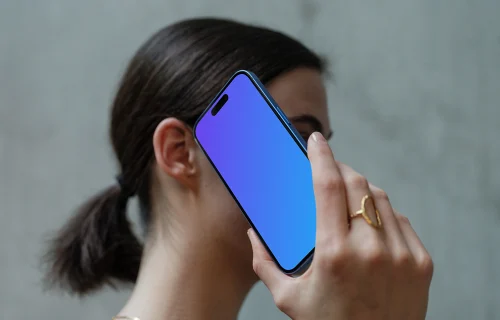 iPhone 16 mockup held in hand against concrete background