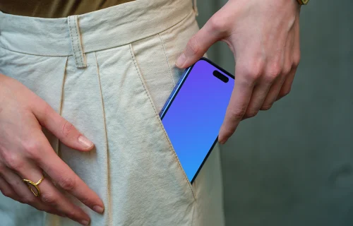 iPhone 16 mockup in hand with casual outfit