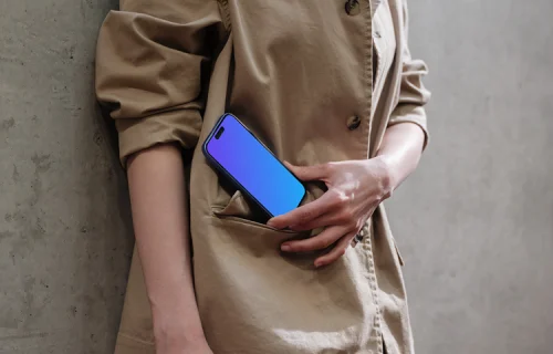 iPhone 16 mockup in woman's hand on concrete background