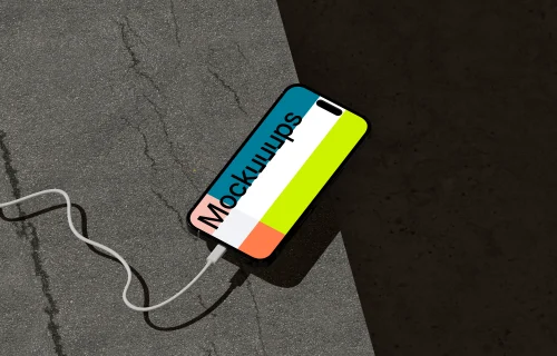 iPhone 16 Mockup on Concrete Surface with Charging Cable