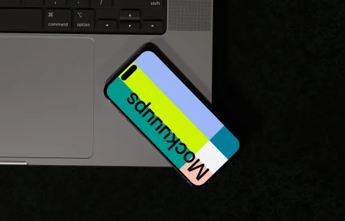 iPhone 16 mockup with laptop angle view