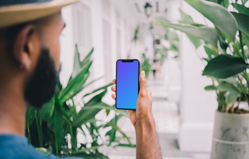 iPhone mockup held in selfie position