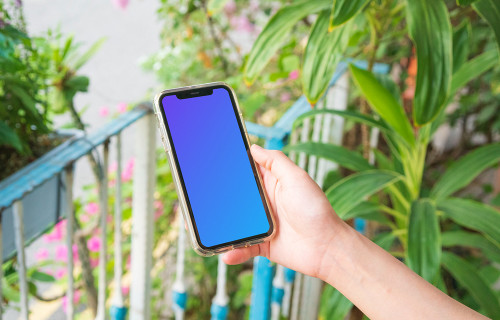 iPhone mockup held on a mockup