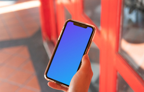 iPhone mockup help by user beside red doors
