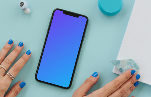 iPhone mockup on a blue table beside a pair of earbuds