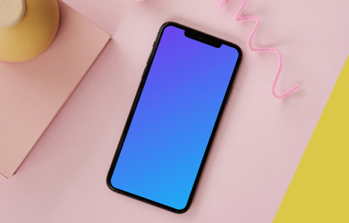 iPhone mockup on a pink table