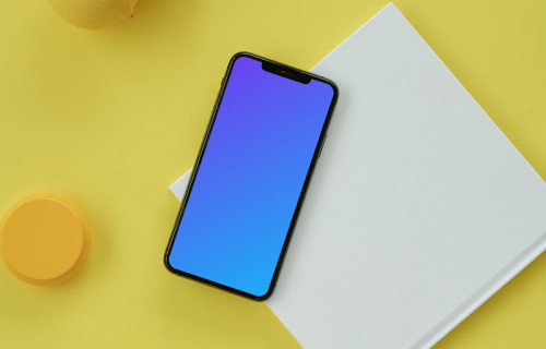 iPhone mockup on a yellow table