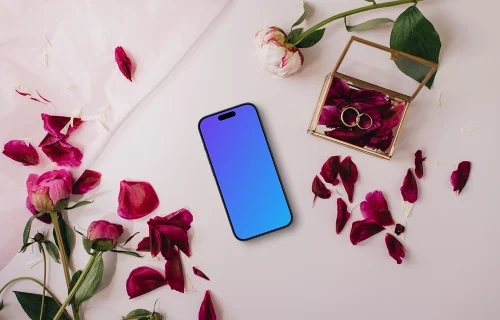 iPhone surrounded by rose petals