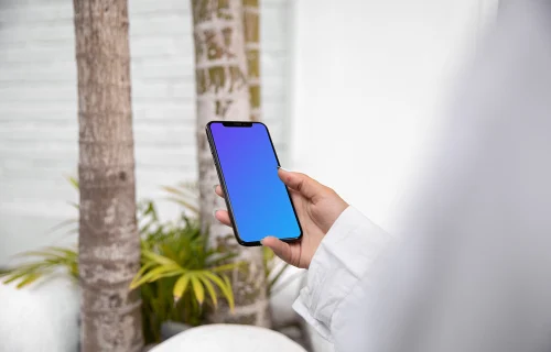 iPhone X mockup in a user’s hand