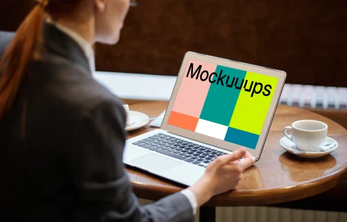 Lady using a MacBook Air mockup with a cup of coffee at the side