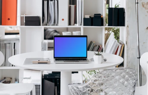 Laptop mockup in an office setting with overhead lamp