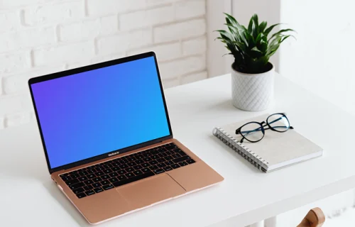 MacBook Air mockup beside a white notebook