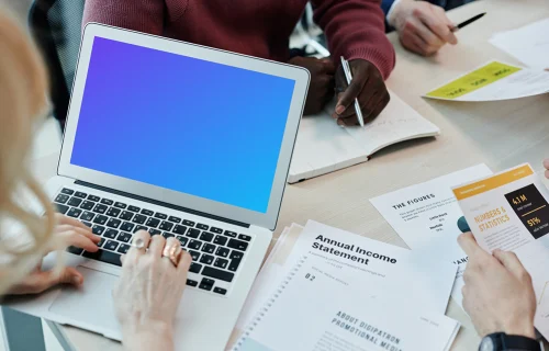 MacBook Air mockup in use at a team meeting