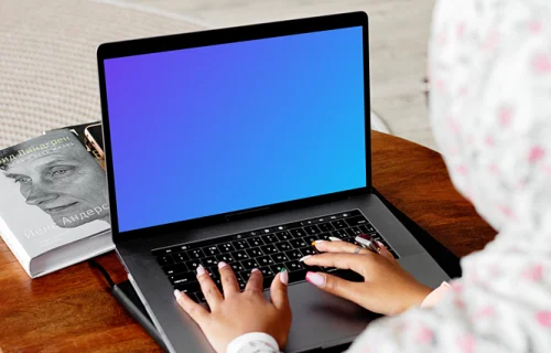 MacBook Air mockup in use by a lady with a head covering