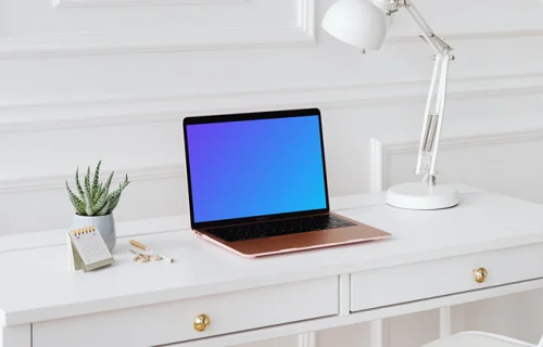 MacBook Air mockup on a desk beside a potted plant