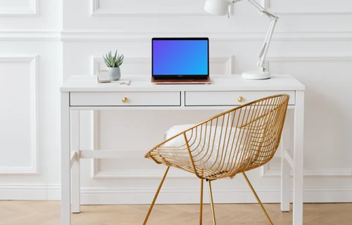 MacBook Air mockup on a table beside a reading lamp