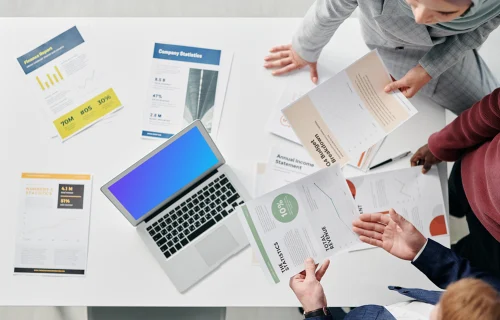 MacBook Air mockup on a table in a business meeting