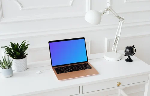 MacBook Air mockup on a table with a globe at the side
