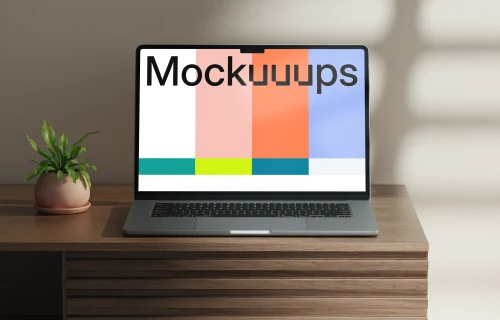 MacBook Air mockup on a wooden desk with a potted plant