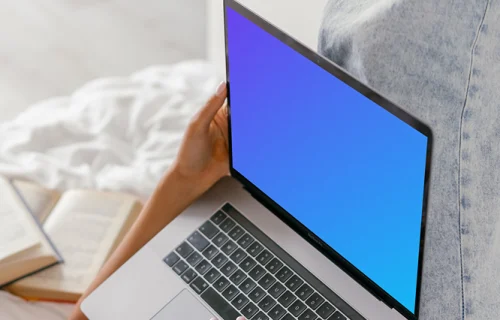 MacBook Air mockup used in bed by a lady