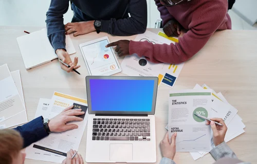 MacBook Air mokcup beside business documents