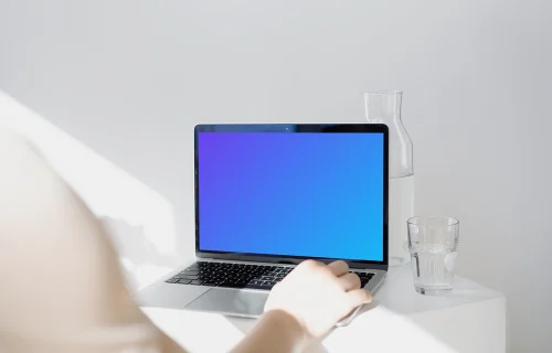 MacBook Pro mockup before a glass jar and tumbler