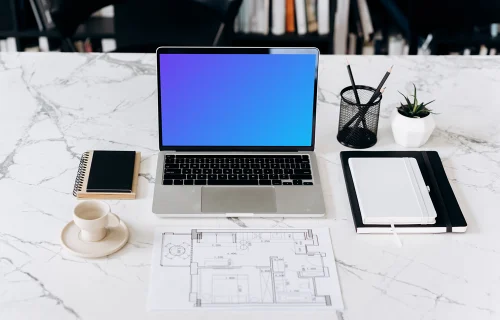 MacBook Pro mockup in front of an architectural plan