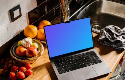 MacBook Pro mockup on a kitchen counter next to bowls of fruits