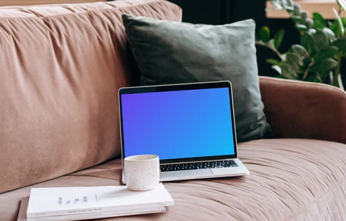 MacBook Pro mockup on a red sofa