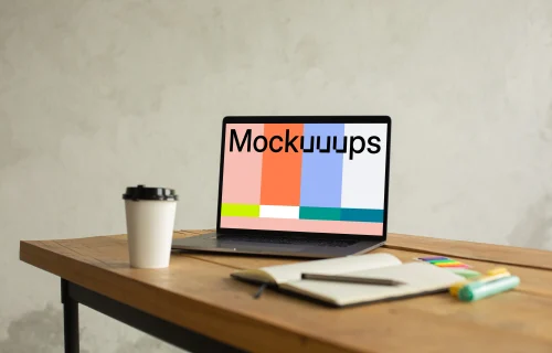 MacBook Pro mockup on a table beside a cup of coffee