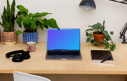 MacBook Pro mockup on a table with an iPad at the side.