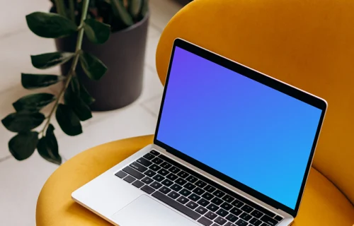 MacBook Pro mockup placed on a yellow chair