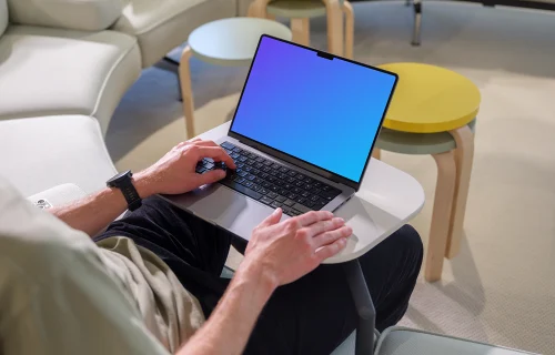 MacBook Pro mockup with a man in a casual workspace