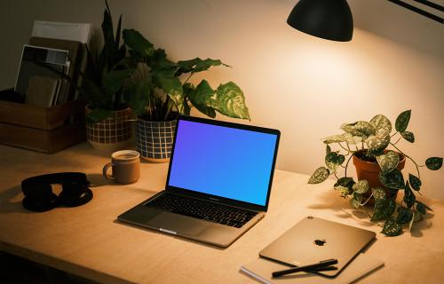 MacBook Pro mockup with a notepad and iPad Air at the side