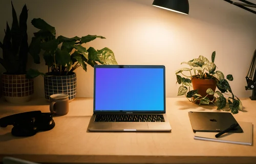 MacBook Pro mockup with a pair of headphones at the side