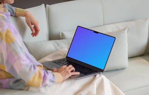 MacBook Pro mockup with woman on a modern sofa