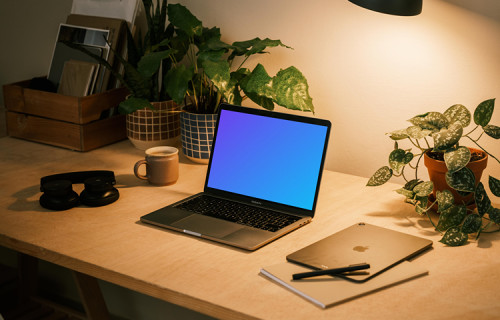 MacBook Pro on table with a pen and an iPad Air at the side