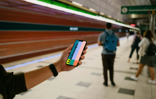 Male hand holding an iPhone 13 mockup