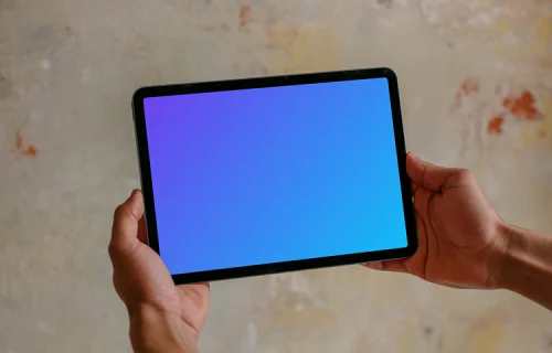 Male hands holding iPad mockup