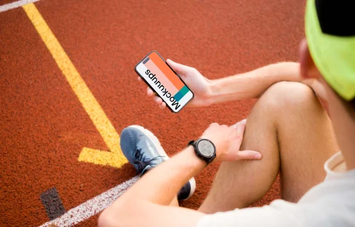 Male runner holding an iPhone 14 Pro mockup