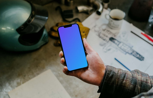 Man holding an iPhone 13 Pro mockup