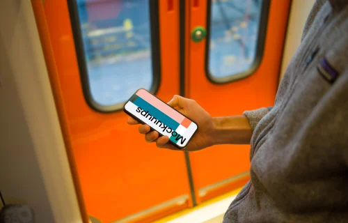 Man holding smartphone on the train