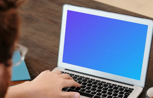 Man in glasses using a MacBook Air mockup