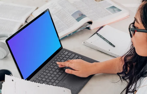 Microsoft Surface laptop mockup used by a lady in glasses
