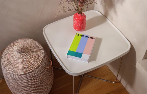 Mockup of a book on a minimalist table with decor