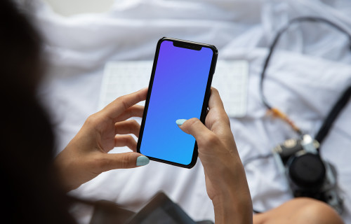 Mockup of lady holding an iPhone in bed