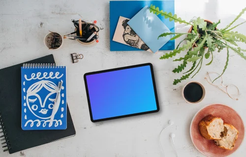 Mockup of tablet device with a plant and coffee on the side