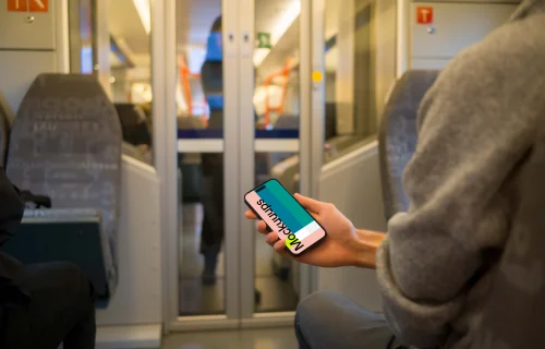 Passenger holding smartphone on the train mockup